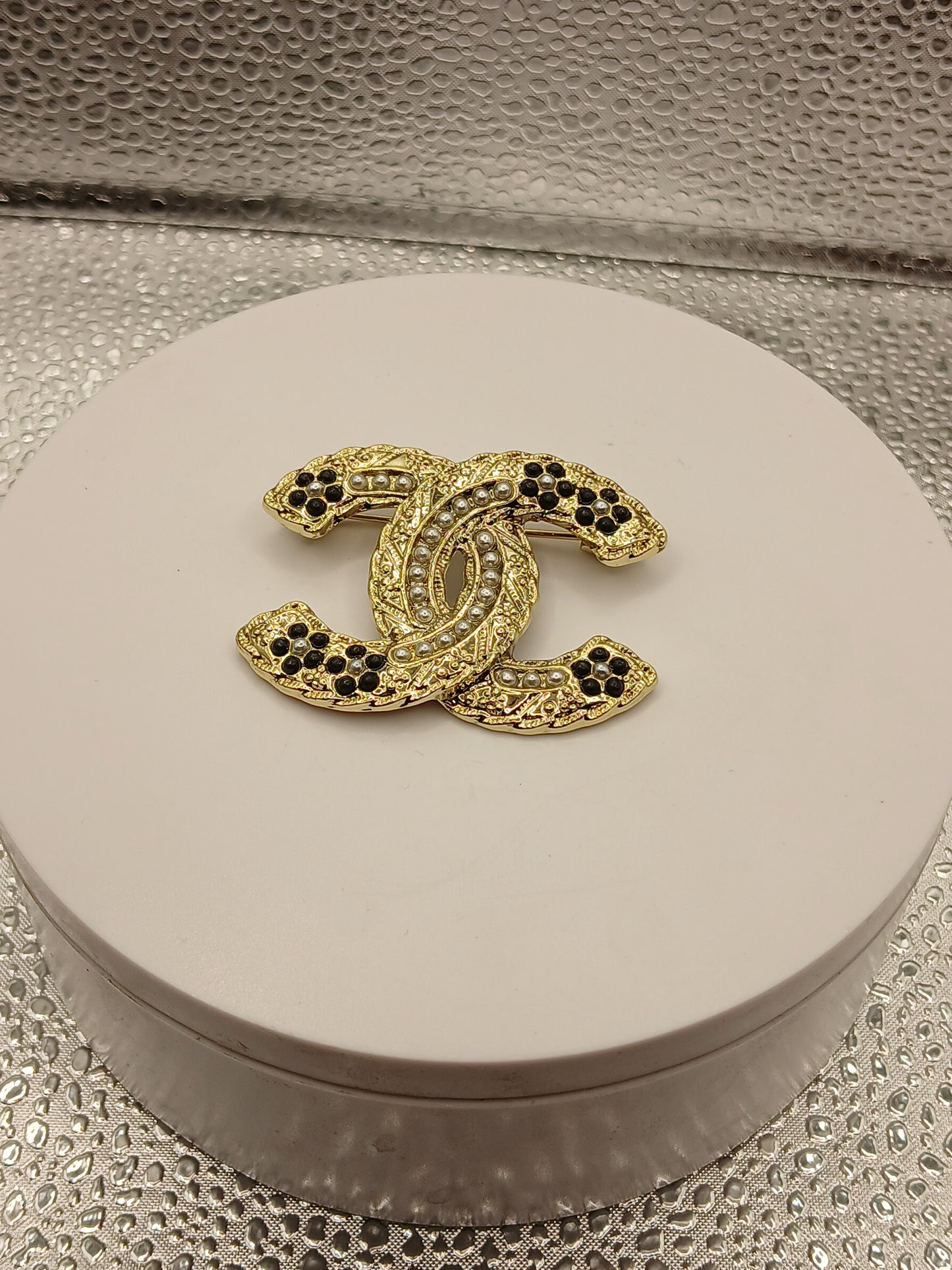 Black C brooch